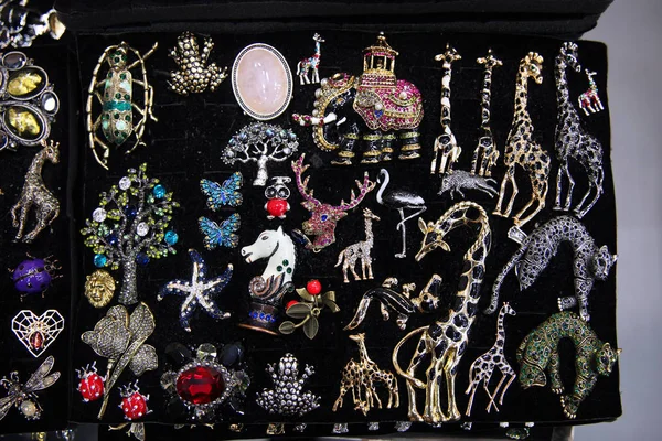 Vintage animal brooches, giraffes, deer, elephant, Jaguar, frogs on dark background