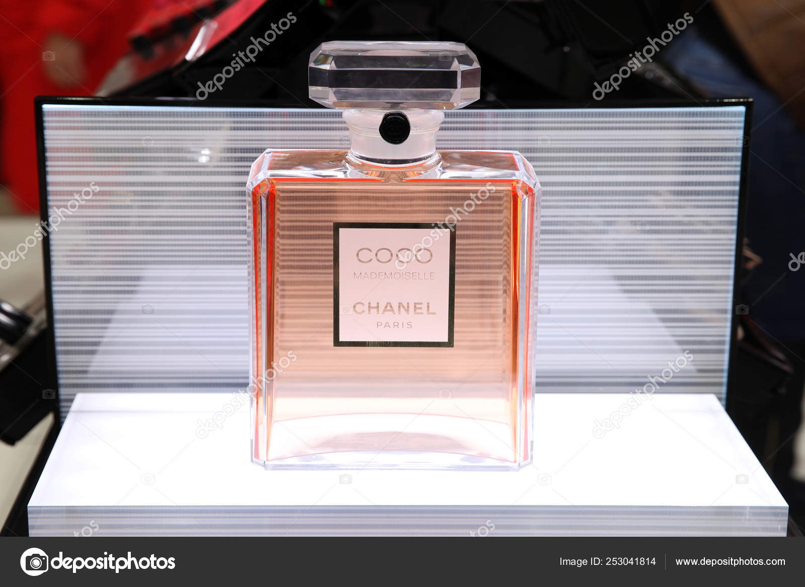 Chanel Perfume Bottle Isolated on Red & Blue Background. Bottle