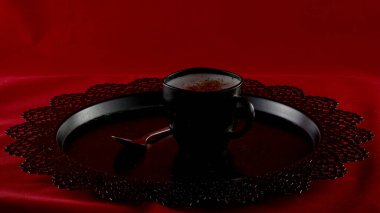 Siyah kadifede siyah bir fincanda taze demlenmiş siyah kahve.