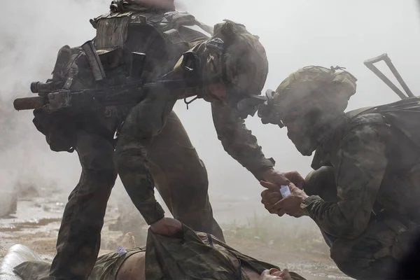Special forces soldiers provide first aid to the victim