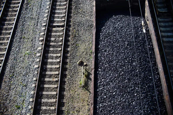 Coal wagon on the railroad, top view. Rails, train with raw materials