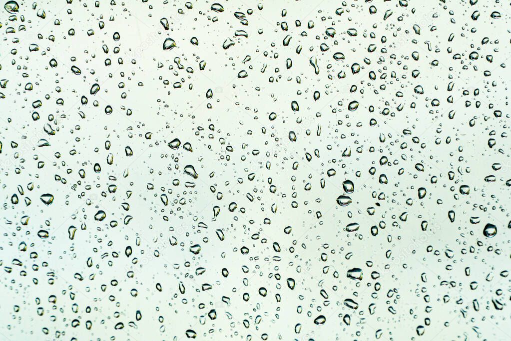 Abstract photo of raindrops on window after heavy rain.