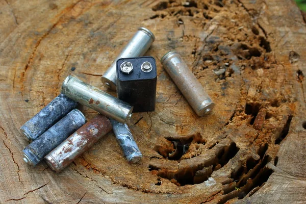 Spent Batteries Coated Corrosion Different Shapes Sizes Lie Edge Wooden — Stock Photo, Image