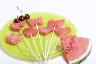 Karpuz hamuru parçalarını bir damga ile kesilir. Onlar farklı biçimleri verilmiştir. Yaylı piknik için şiş üzerinde. Kalenin yanındaki karpuz parçaları ve tatlı kiraz birkaç çilek vardır.