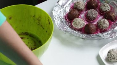 Bir kadın kakao tozu ve bisküvi çikolata sosis yapıyor. Sosis için gıda film hamur yayılır. Hazır tatlılar yalan üzerine uçan daireler.