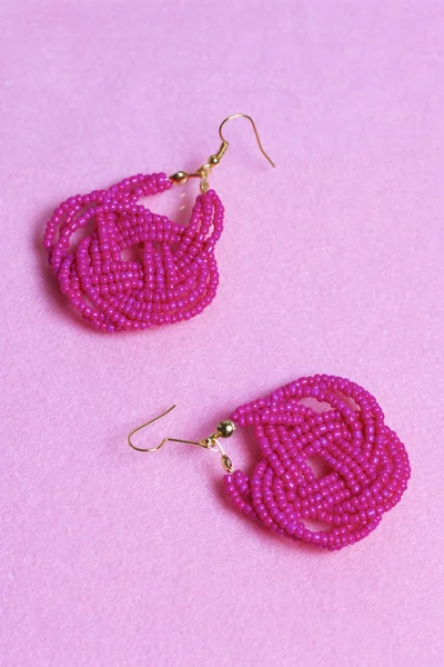 Earrings from beads handmade. Pink colour. Needlework at home. Bead jewelery.