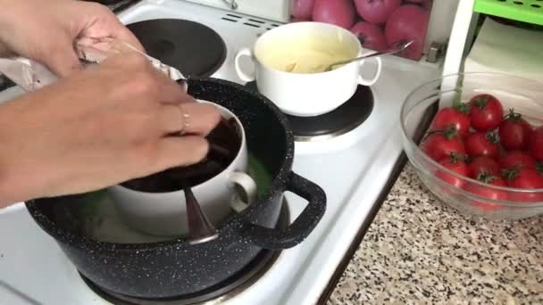 Woman Adds Pieces Chocolate Container Melt Pieces Black White Chocolate — Stock Video