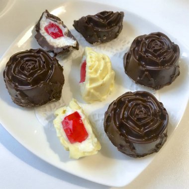 Ev yapımı sırlı lor barlar, beyaz ve siyah çikolata kaplı. Bir tabağa yalan. Bazı ikiye kesilir. Süzme peynir ve meyve jöle görünür doldurma.