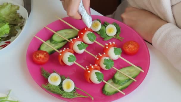 女性は マヨネーズのキノコ キャップを飾る キノコは ウズラのゆで卵 トマトの半分から作られています 彼らは木製の串でつなぎは — ストック動画