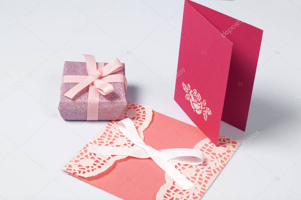 Handmade greeting cards. Near gift in wrapping paper, tied with a ribbon. Original gift.