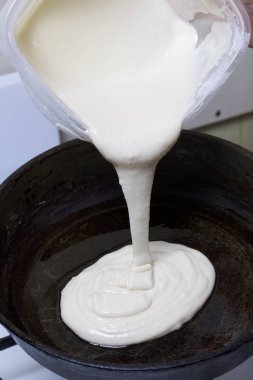 Yemek pasta mascarpone krema ile. Bir kadın meyilli bir sıcak tava dökülen..