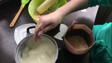 Kadın kalıp krema ekleyin. Yemek kek bisküvi kırıntıları ve süt jöle.