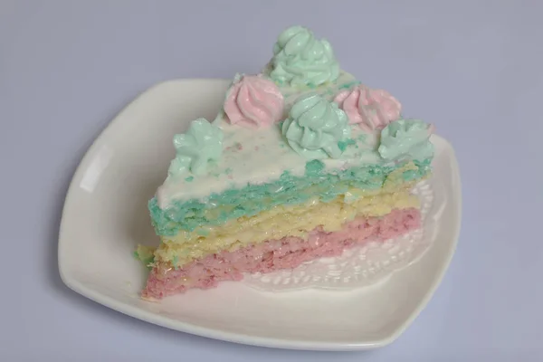 The piece is cut off and lies side by side on a saucer. Waffle cake made from cream soaked cakes. Decorated with cream flowers. — Stock Photo, Image