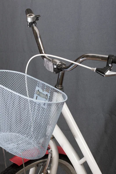 Elements of a female bicycle in white and pink color.  Steering wheel and luggage basket. Spring and summer recreation and sports.