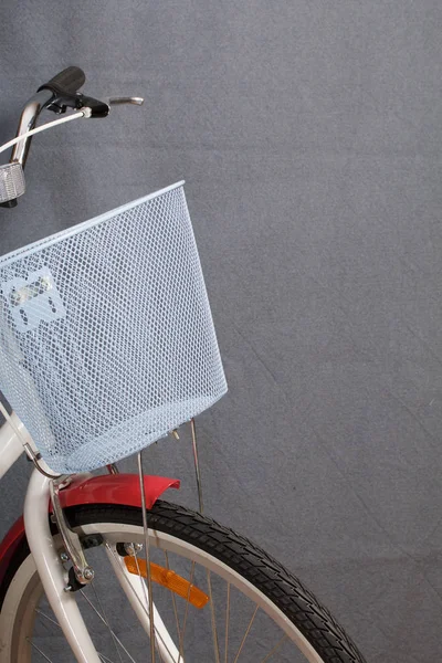 Elements of a female bicycle in white and pink color.  Steering wheel and luggage basket. Spring and summer recreation and sports.