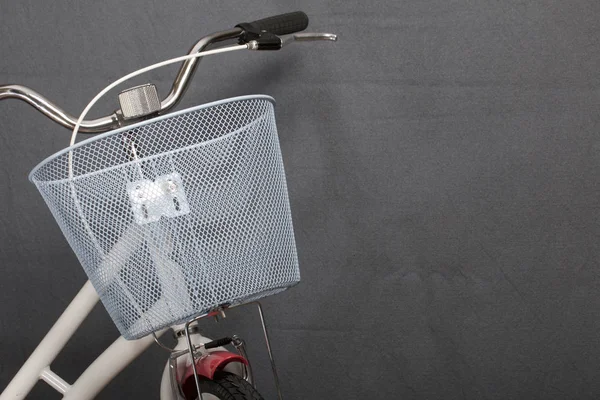 Elements of a female bicycle in white and pink color.  Steering wheel and luggage basket. Spring and summer recreation and sports.