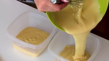 Bir kadın pişmiş hamur iki kapsayıcı böler..