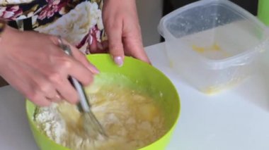 Pasta için hamur hazırlama kadın. Malzemeler hamur yapmak için bir kap içinde karışımları.