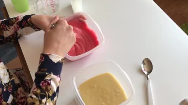Woman Adds Drop Dye Batter Mixes — Stock Video