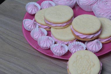 Pişmiş marshmallowlu sandviç. Tabakta yatıyorlar. Tabakta bir sonraki çeşitli boyutlarda bir marshmallow olduğunu.