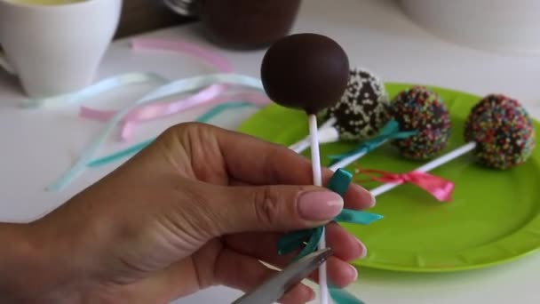 Woman Decorates Bows Braid Cake Pops Puts Plate Candy Decorated — Stock Video