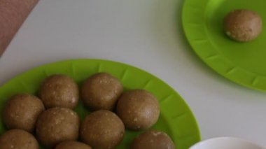 Tabakta yoğunlaştırılmış sütlü bisküvi topları vardır. Bir kadın popcake boşluklar şekil verir.