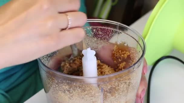 Woman Checks Degree Grinding Almonds Blender Bowl Preparation Filling Glazed — Stock Video