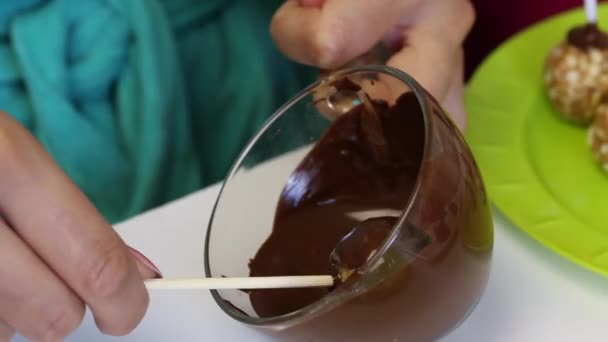 Woman Dips Popcake Billet Melted Black Chocolate — Stock Video