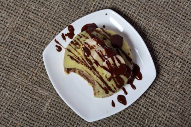 Kaba keten kumaş. Muzlu magkekli bir tabağı var..