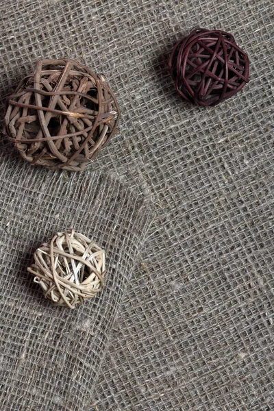 Coarse linen fabric. On it are rattan balls. — Stock Photo, Image