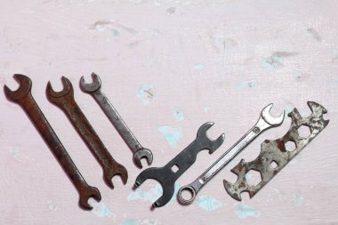 Farklı boyutlar için anahtarlar. Yıpranmış ve korozyon ile kaplı. Soyma boyası ile yüzeye uzanın.