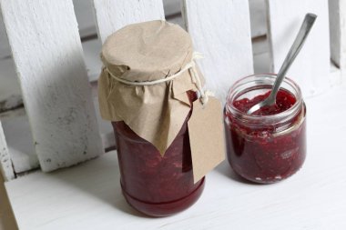 Reçel kavanozları, kağıt ile kaplıdır ve ikiyle bağlanmış. Dize asmak Craft etiketleri. Bir kavanoz açık.