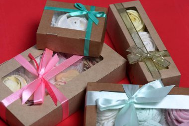 Hediye kutularında farklı renklerde Marshmallows. Kutular bir yay bağlı renkli bir kurdele ile bağlı. Yukarıdan görüntüle.