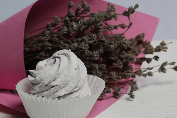 Marshmallows de lavanda em uma cesta de papel. Perto de um buquê de lavanda envolto em papel . — Fotografia de Stock