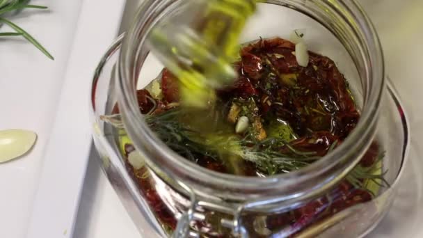 Woman Adds Olive Oil Jar Dried Tomatoes Has Branch Rosemary — Stock Video