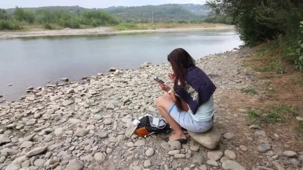Une Fille Est Assise Sur Bord Une Rivière Montagne Regarde — Video