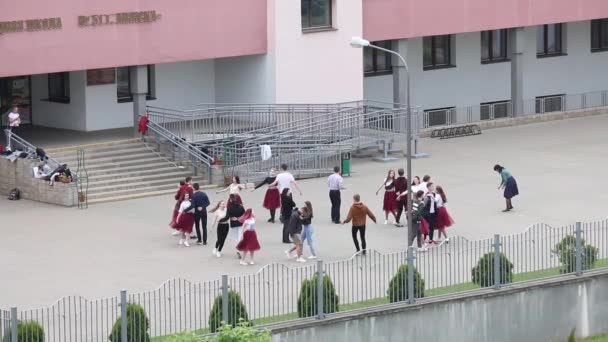 MINSK, BELARUS MAY 29, 2020 Graduados ensayando un vals escolar. Niños y niñas realizan movimientos de baile . — Vídeo de stock