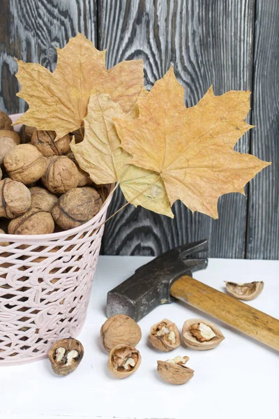 Basket Walnuts Nearby Lies Hammer Chopped Nuts Dried Maple Leaves — Stock Photo, Image