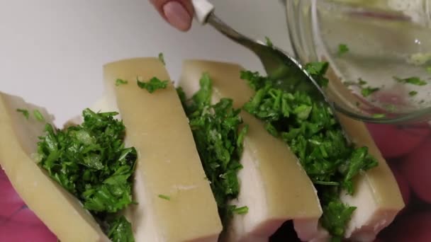 A piece of bacon, cut into an accordion. The woman puts parsley and garlic in it. Salted lard with herbs and spices. — Stock Footage A piece of bacon, cut into an accordion. The woman puts parsley and garlic in it. Salted lard with herbs and spices. Royalty Free Stock Footage