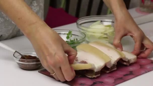 The woman demonstrates the lard cut into an accordion. Next in containers are parsley with garlic and adjika. Salted lard with herbs and spices. — Stock Footage The woman demonstrates the lard cut into an accordion. Next in containers are parsley with garlic and adjika. Salted lard with herbs and spices. Royalty Free Stock Footage