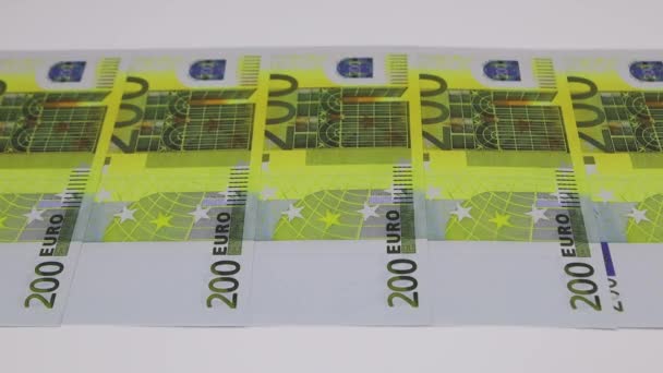 200 евро банкноты лежат на белом фоне сметены вручную, FullHD — стоковое видео