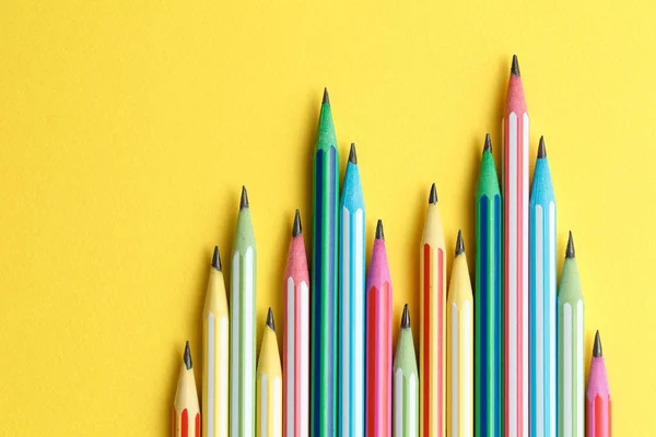 Multicolored pencils on a yellow isolated background — Stock Photo, Image