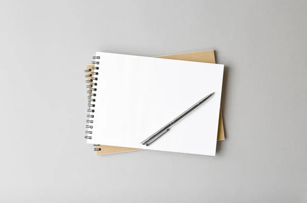 top view of a open notebook with pen on a gray background