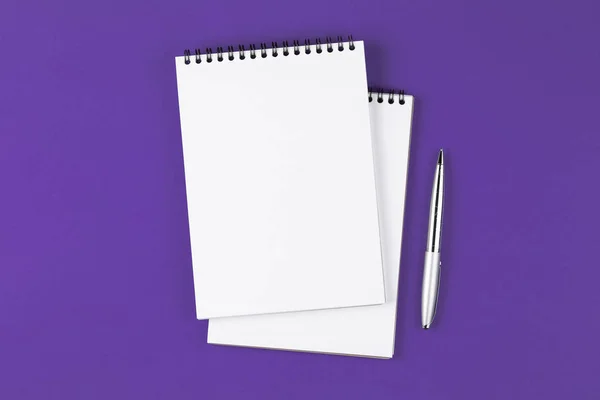 Notebook aperto con penna sullo sfondo viola — Foto Stock