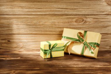 Ahşap arkaplan görünümlü kurdeleli hediye kutusu. 