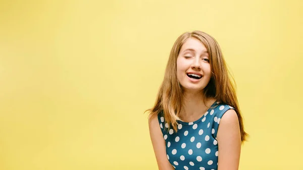 cheerful girl on yellow background smiling. happy model in studio
