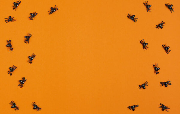background for halloween, spiders on an orange table