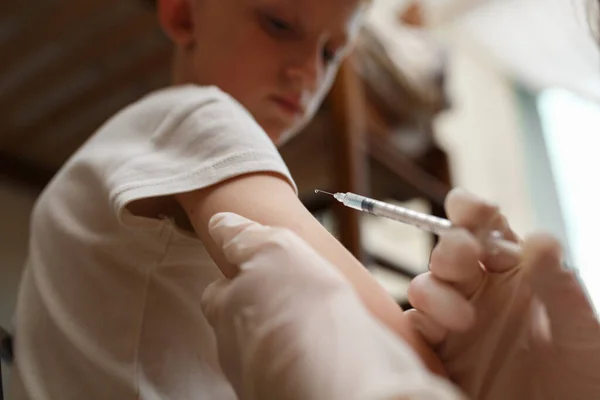 Le pédiatre fait la vaccination au petit garçon. — Photo