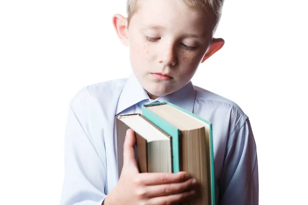 Menino assustado com livros nas mãos — Fotografia de Stock