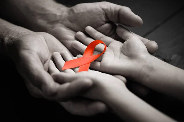 AID red ribbon in hand